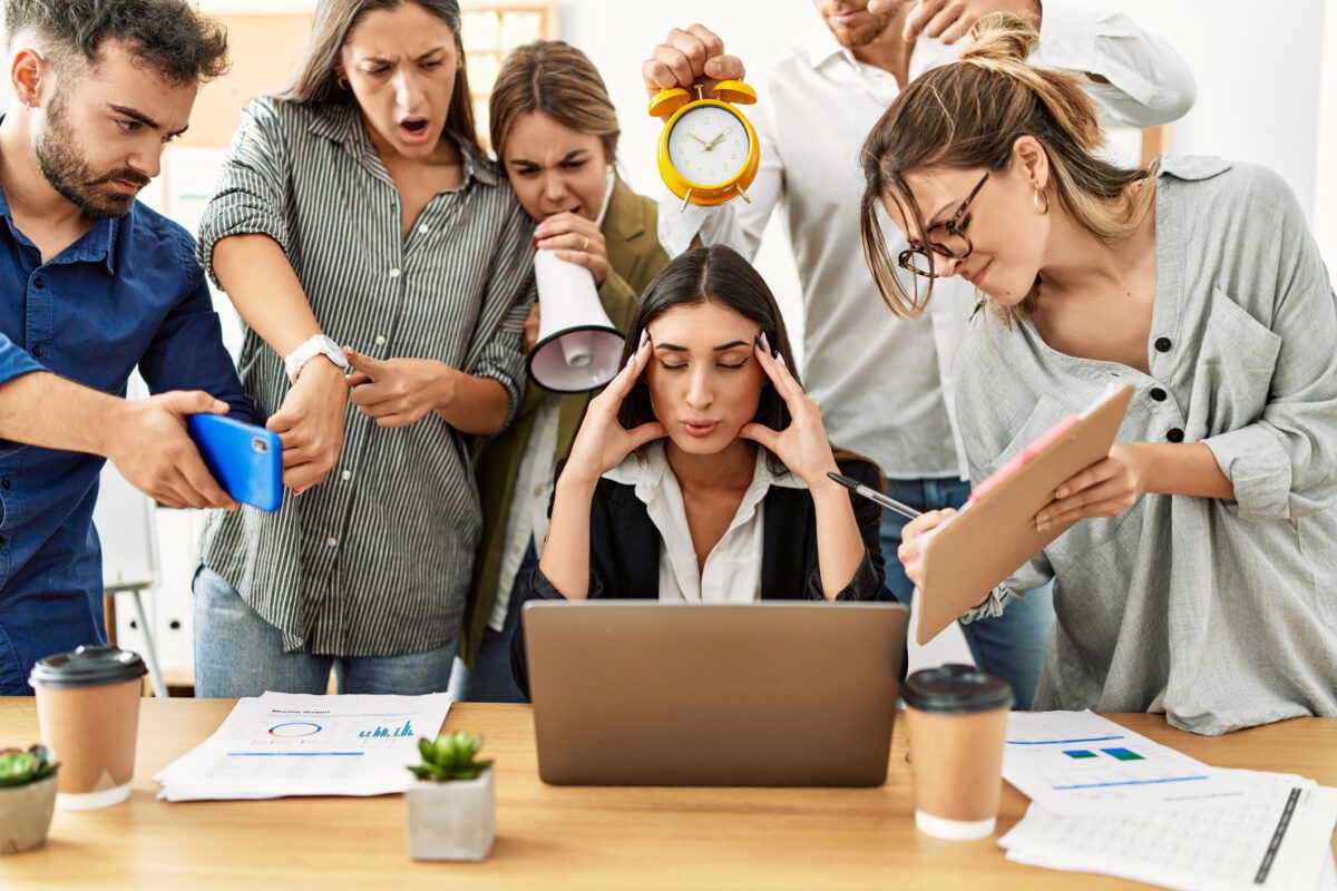 Group of business workers screaming to stressed partner at the office. Group of business workers screaming to stressed partner at the office.